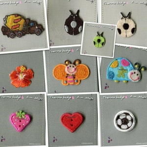 May include: Assortment of iron-on patches featuring various designs, including a ladybug, a butterfly, a flower, a strawberry, a heart, a football, and a cement mixer. The patches are all on white backgrounds with the text "Thermo badge La Mode" printed on each.