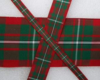 May include: Red, green, and white plaid ribbon with a white background. The ribbon is woven with a tartan pattern.