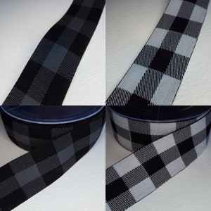 May include: Two rolls of black and white checked elastic. The elastic is 2.5 cm wide and has a checkered pattern.