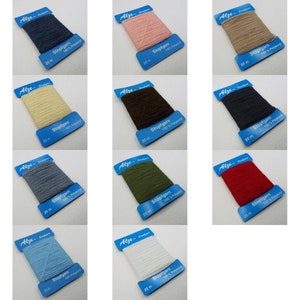 May include: Twelve spools of Stopfgarn 100% Polyacryl yarn in various colours, each spool is labelled with the brand name Alze and the length of the yarn, 20 metres.