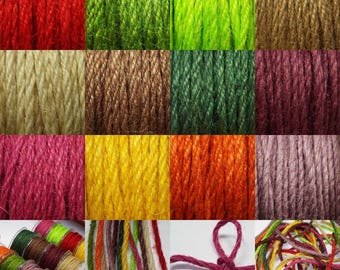 May include: Assortment of colorful jute twine in various shades, including red, green, brown, yellow, orange, pink, and purple. The twine is arranged in rows, showcasing the different colors and textures.