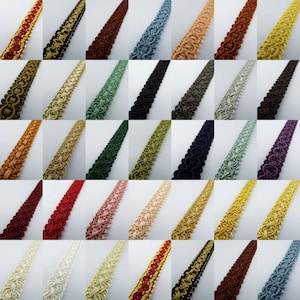 May include: A collection of 36 different colours of trim, each with a unique pattern. The trim is made of a woven fabric and has a slightly raised texture. The trim is approximately 2.5 cm wide.
