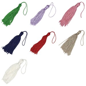 May include: Assortment of ten colourful tassel trims with loops. The tassels are in the colours green, purple, pink, red, beige, and white.