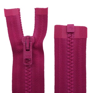 May include: A pink zipper with a metal slider. The zipper is open and the slider is in the middle of the zipper. The zipper is made of a woven fabric and has a textured surface.