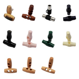 May include: Assortment of 10 toggle buttons in various colours and materials, including wood, plastic, and metal. The buttons are designed for use in clothing and other crafts.