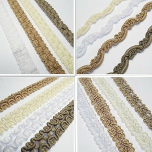 May include: Assortment of decorative trim in white, cream, and brown colours. The trim is made of woven cord and features various patterns, including a simple braid, a rope-like design, and a more intricate floral pattern.