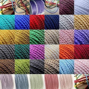 May include: A variety of colours of twisted cord, each colour is shown in a separate square. The cord is a thick, braided rope.