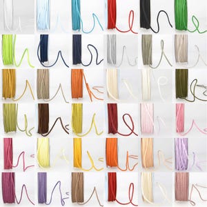 May include: Assortment of 24 spools of colourful waxed cotton cord. Each spool contains approximately 9 metres of cord. The cords are arranged in rows of six, with each row featuring a different colour palette.
