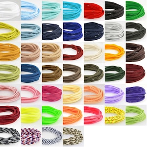 May include: Assortment of 36 spools of colourful braided cord, each spool containing approximately 9 metres of cord. The cords are arranged in rows of six, with each row featuring a different colour palette.