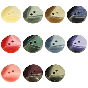 May include: Assortment of 10 two-hole plastic buttons in various colours and patterns. The buttons are round and have a three-dimensional design.