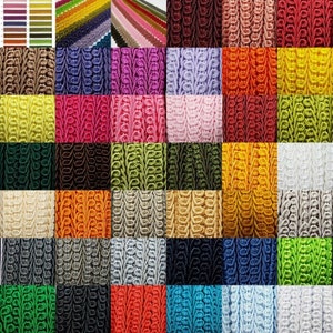 May include: A variety of colours of decorative trim with a woven pattern. The trim is arranged in a grid pattern.