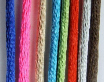 May include: A collection of eight different colored cords, including blue, pink, beige, turquoise, green, red, gray, and brown.