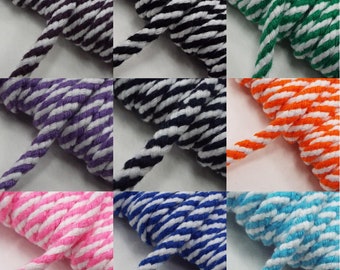 May include: A collection of striped cotton cords in various colors, including black, white, purple, green, orange, blue, pink, and turquoise. The cords are all approximately 1/4 inch thick and have a white stripe running down the center.