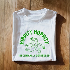 hippity Hoppity I'm clinically depressed Unisex Heavy Cotton TeeRism, boneyisland funny Travel Clothing