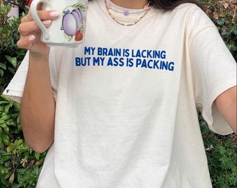 my brain is lacking but my ass is packing  Unisex Heavy Cotton Tee