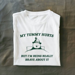 My Tummy Hurts but Im Being Really Brave About It Unisex Heavy Cotton Tee Unisex Heavy Cotton TeeRism, boneyisland funny Travel Clothing