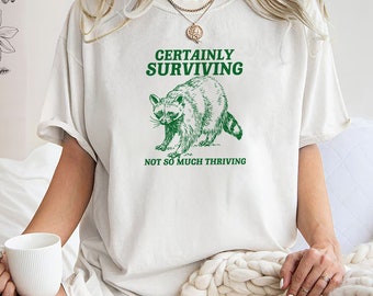certainly surviving not so much thriving Unisex Heavy Cotton Tee