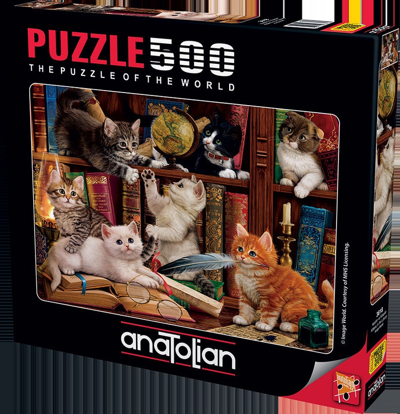 May include: A 500-piece jigsaw puzzle featuring a whimsical scene of kittens in a library. The kittens are playing with books, a quill pen, and a globe. The puzzle box features the text "The Puzzle of the World" and the brand name "anatolian".