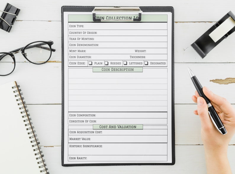 May include: A black clipboard with a white sheet of paper with a coin collection log form. The form has fields for coin type, country of origin, year of minting, coin denomination, mint mark, coin diameter, coin edge, weight, thickness, and coin description. The form also has fields for coin composition, condition of coin, coin acquisition cost, market value, historic significance, and coin rarity.