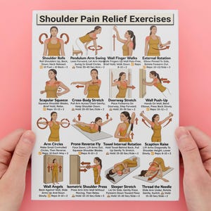 May include: A white poster titled "Shoulder Pain Relief Exercises" with illustrations of various stretches. The poster is held by hands against a pink background. The exercises include Shoulder Rolls, Arm Circles, and Wall Angels.