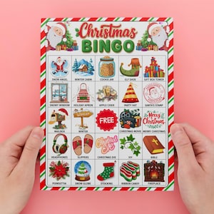 May include: A Christmas Bingo game card with a red and green border, held by hands against a pink background. The card features festive illustrations and the text "Christmas BINGO". Images include Santa, a snowman, and a Christmas tree.