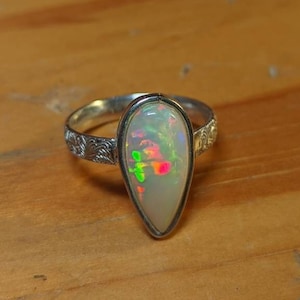 Handmade Ethiopian rainbow opal ring set in .925 silver sterling. Size 6.5/Size N