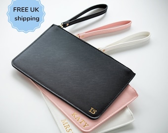 May include: Three personalized leather clutches in black, pink, and white. The clutches have gold lettering with the names "MRS B", "KATY", and "IS".