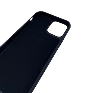 May include: Black phone case with a cutout for the camera lens.