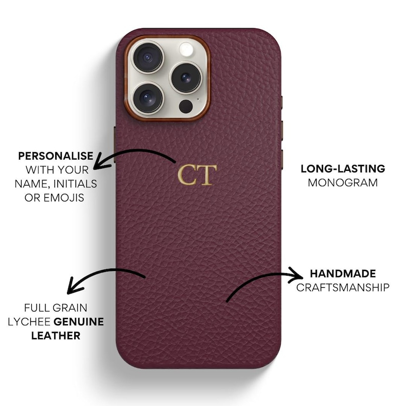 May include: A burgundy leather phone case with a gold monogram "CT" and a camera lens cutout. The case is made of full grain lychee genuine leather and features handmade craftsmanship.