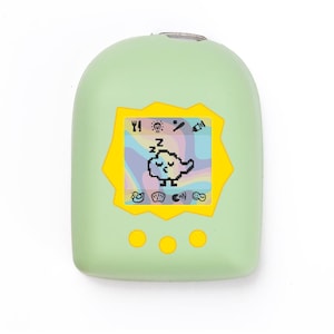 Può includere: Un dispositivo elettronico portatile verde chiaro con un bordo giallo attorno allo schermo. Lo schermo mostra una grafica di uccello che dorme su uno sfondo arcobaleno. Tre pulsanti gialli sono sotto lo schermo.