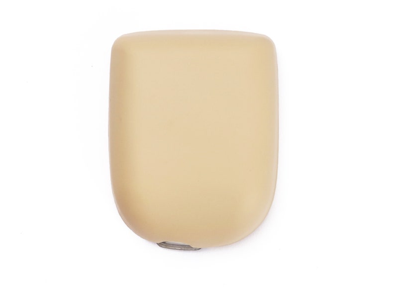 May include: A beige, oval-shaped, plastic soap dispenser with a silver pump.