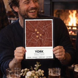 May include: A framed map print of York, North Yorkshire, featuring a dark red street grid with four numbered yellow circular markers. The text reads: OUR YORK, YORK, NORTH YORKSHIRE, 53.9590°N / 1.0815°W, 1 THE SNUG, 2 THE BRIDGE, 3 SUNDAY ROAST, 4 LAST ORDERS.