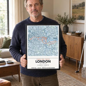 May include: A framed map print of London featuring a highlighted orange marathon route over a blue and white street grid. The text reads: THANK YOU, COACH, LONDON, 26.2 MILES, 51.4930 N / 0.0387 W, SARAH HILL - 3:44:10 - FROM ALL OF YOUR RUNNERS.