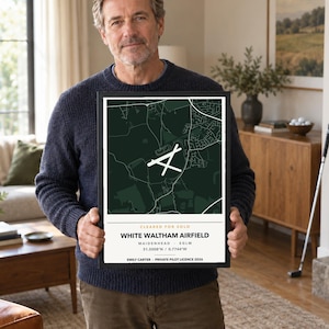 May include: A framed rectangular print featuring a dark green map of White Waltham Airfield with white runway markings. The bottom section includes the text CLEARED FOR SOLO, WHITE WALTHAM AIRFIELD, MAIDENHEAD, EGLM, 51.5008 N / 0.7744 W, EMILY CARTER, PRIVATE PILOT LICENCE 2026.