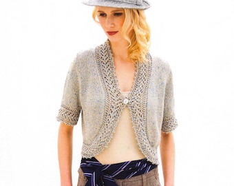 May include: A woman's outfit featuring a gray hat, a short-sleeved, light-colored knitted bolero, and wide-legged brown trousers. A blue and white striped tie is tied around the waist. The text "Louisa Harding" is written in cursive.