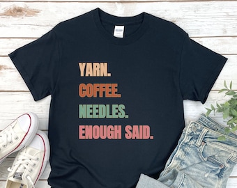 May include: Black t-shirt with the text "YARN. COFFEE. NEEDLES. ENOUGH SAID." in colorful letters.