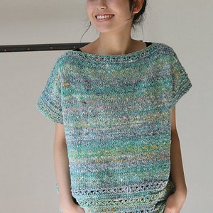 May include: A teal, green, and pink short-sleeved knit top with a loose fit and a crocheted trim.