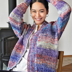 May include: A colorful striped cardigan with a loose fit and long sleeves. The cardigan is made of a soft, textured yarn and has a relaxed, casual style.