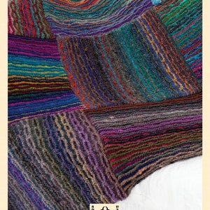 May include: A colourful knitted throw blanket with a patchwork design in shades of purple, blue, green, red, and brown. The blanket is made with a textured yarn and has a soft, cosy feel.