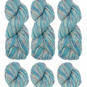 May include: Ten skeins of yarn in a blue, white, and pink colorway. The yarn is arranged in three rows of three skeins, with one skein at the bottom.