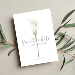 Puede incluir: Tarjeta blanca con una ilustración de acuarela de un lirio de agua y el texto "Save the date" con los nombres Helena & Carlos y la fecha 14 de noviembre de 2017. La tarjeta está rodeada de hojas verdes.