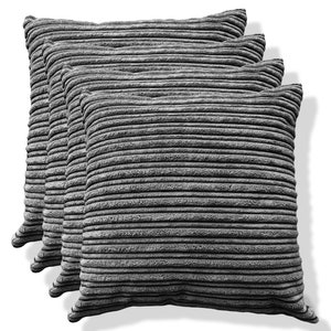 May include: Four grey corduroy throw cushions stacked on top of each other. The cushions are all the same size and have a ribbed texture.