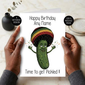 May include: A white birthday card with the text "Happy Birthday Any Name" and "Time to get Pickled !!". The card features a cartoon pickle character wearing a hat with green, yellow, and red stripes.