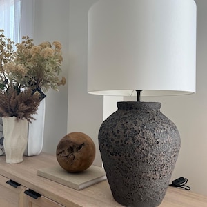 Blackish, dark textured giant ceramic table lamp with white fabric shade