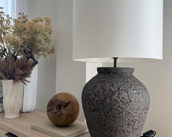 Blackish, dark textured giant ceramic table lamp with white fabric shade