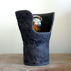 Blackish modern round textured surface ceramic table lamp, a statement lamp, one of a kind surface