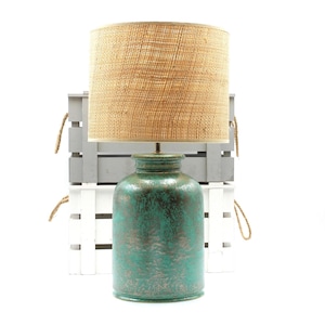 Green ceramic table lamp with metallic - silvery/antique golden effects with Raffia/rattan drum shade.