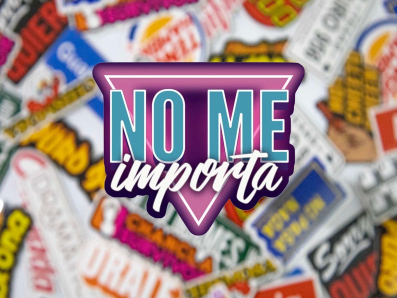 May include: A pink, purple, and blue triangle sticker with the text "NO ME importa" in a white, cursive font. The sticker is on a background of many other stickers with various colors and designs.