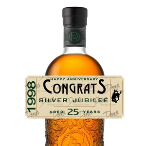 May include: A brown glass bottle with a label that says "Happy Anniversary Congrats Silver Jubilee Aged 25 Years 1998".