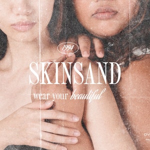 May include: Two women with brown hair are embracing. The woman in the front is wearing a black tank top. The woman in the back is wearing a white tank top. The text "SKINSAND wear your beautiful" is superimposed on the image. The text "1994" is in a circle above the text "SKINSAND". The text "OVERLAY 31 & 47 FROM DARLA STUDIO CO." is at the bottom of the image.